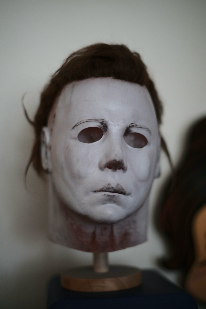 Dark Labs Cosmic Shape mask angled front view with weathered paint and brown hair