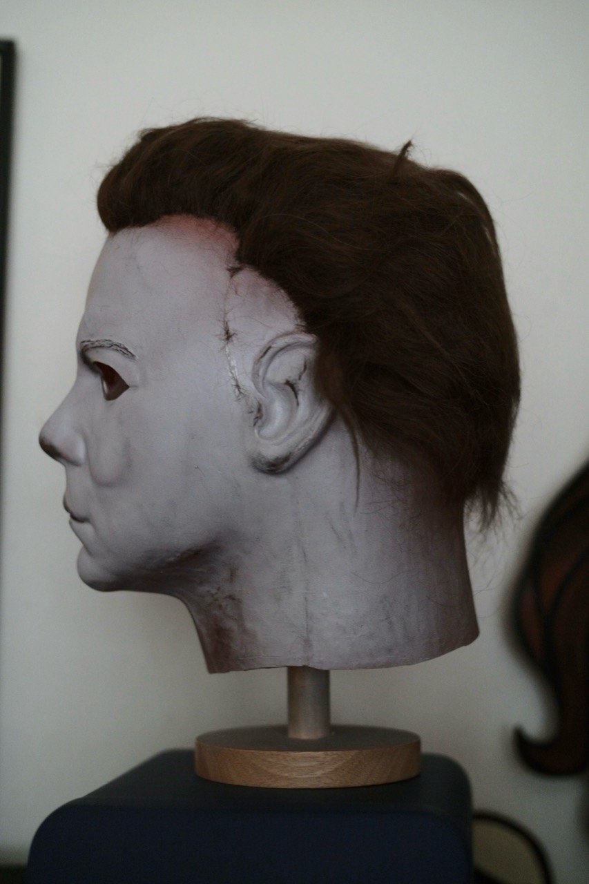 Dark Labs Cosmic Shape mask in left-facing profile on a display stand