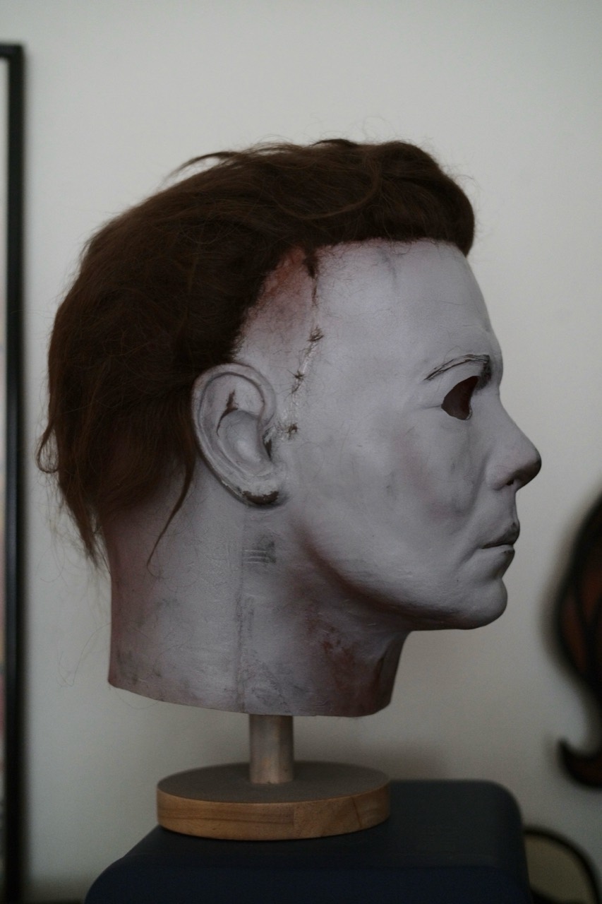 Dark Labs Cosmic Shape mask in right-facing profile on a display stand