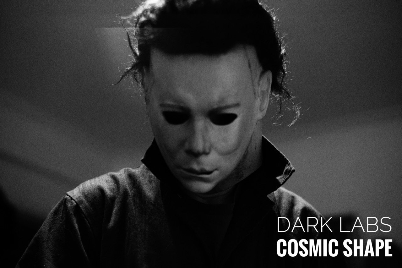 Black and white photograph of Cosmic Shape worn with the head tilted down and Dark Labs branding